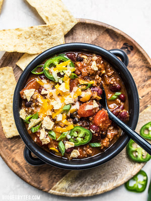 
                  
                    Load image into Gallery viewer, A bowl of Basic Chili topped with cheese, jalapeños, and tortilla chips
                  
                