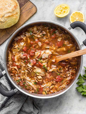 
                  
                    Load image into Gallery viewer, Beef and cabbage soup in the pot with a wooden spoon in the middle
                  
                