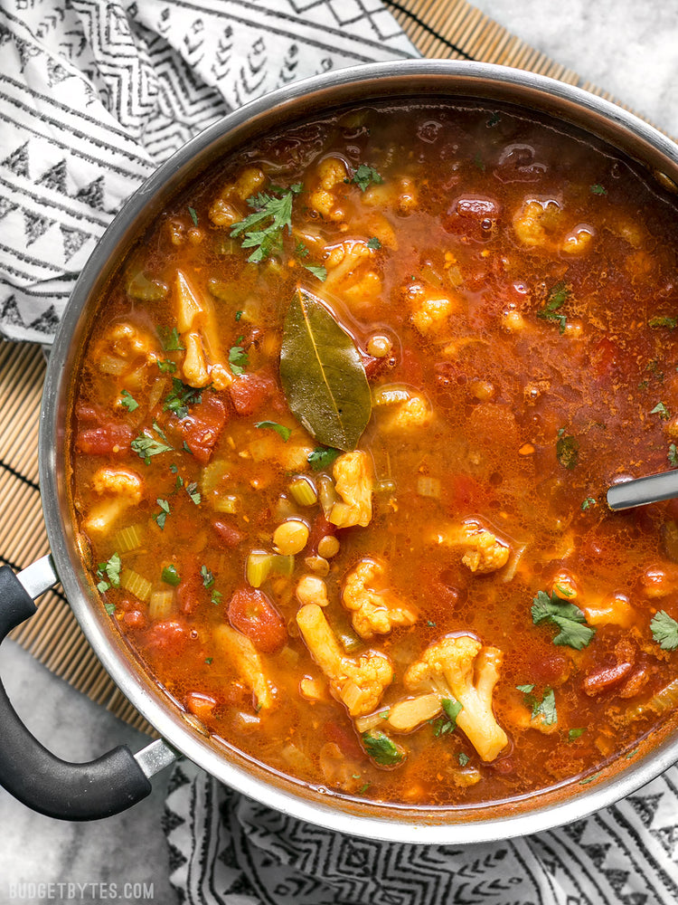 
                  
                    Load image into Gallery viewer, Moroccan Lentil and Vegetable Stew in the pot on a black and white napkin
                  
                